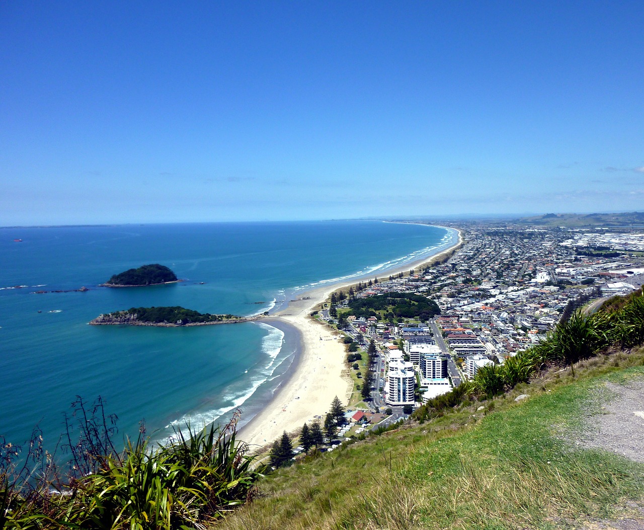 View of Maunganui beach, and Moturiki and Motuotau Islands from the top of Mount Maunganui on a calm day.